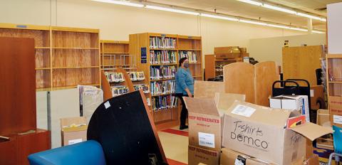 Re-assembling the library is just one of several things Snowbird is doing during its temporary stint in the Ingles Shopping Center. Photos by Art Miller/amiller@grahamstar.com