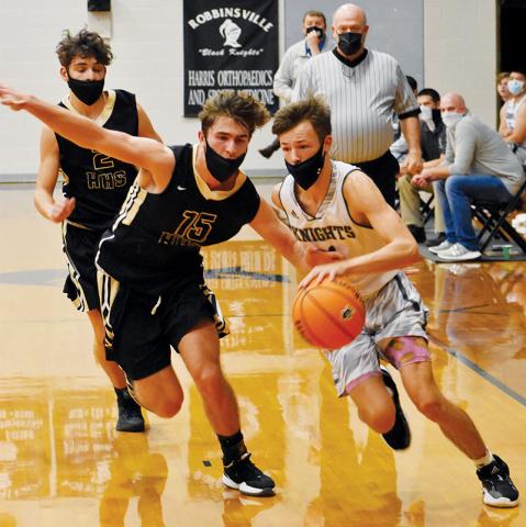 Brock Adams races past Hayesville's Brady Shook on a fast break during Friday's 60-56 loss to the Jackets. Photo by Kevin Hensley/editor@grahamstar.com