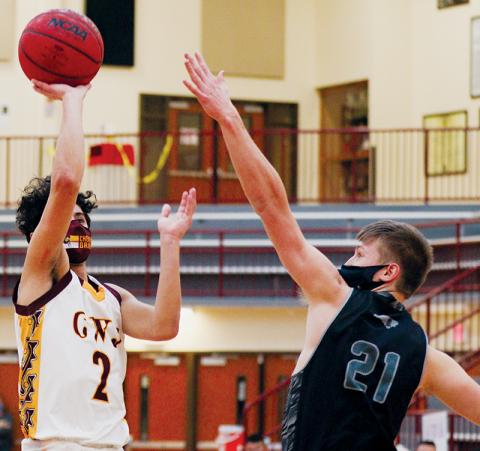 Robbinsville’s Drey Keener (21) reaches out to stop a shot from Cherokee’s Jordan Arkansas during Friday’s 100-81 loss to the Braves. Photo by Scot McKie/Cherokee One Feather