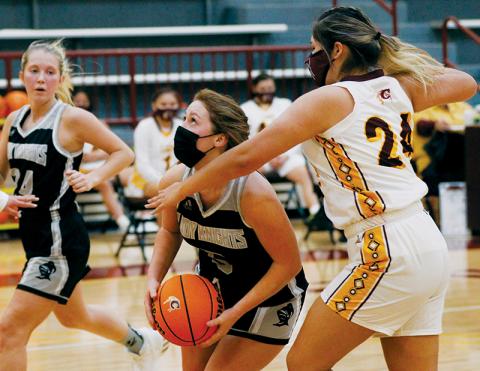 With Kensley Phillips (left) sprinting to back up the drive and Cherokee’s Praire Toineeta attempting to thwart the push, Robbinsville’s Halee Anderson eyes the basket during Friday’s 70-57 road loss to the Lady Braves. Photo by Scot McKie/Cherokee One Feather