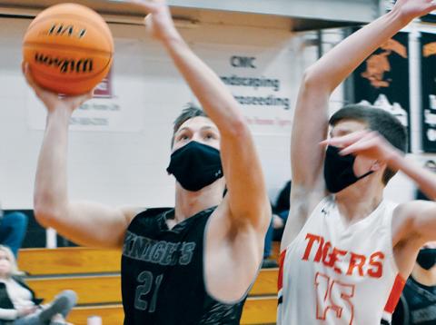 With Luke Hawk (right) closing in, Robbinsville senior Drey Keener eyes a layup Friday at Rosman. Along with Kamdyn Jordan, Keener had a team-high 14 points in the Black Knights’ 61-20 win over the Tigers. Photos by Kevin Hensley/editor@grahamstar.com