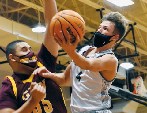 Sophomore point guard Brock Adams soars past Cherokee’s Tariq Underwood during Feb. 9’s home match-up with the Braves. Adams was one of four Robbinsville boys named to the All-Conference team. Photo by Kevin Hensley/editor@grahamstar.com