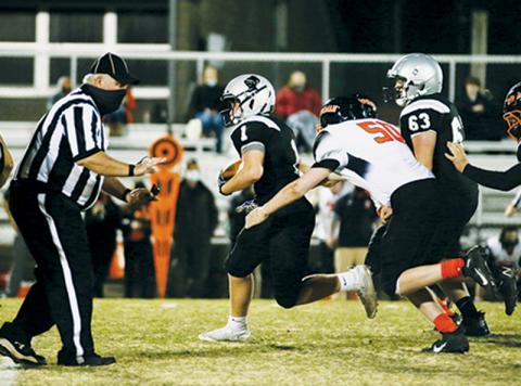 Turner Jackson (1) pulls away from some heavy Rosman pressure during Robbinsville’s 56-6 win over the Tigers on Feb. 25. Jackson emerged as the Black Knights’ leading rusher in the victory, tallying 71 yards on just five carries. Photos by Montana Buchanan/Robbinsville High School Yearbook