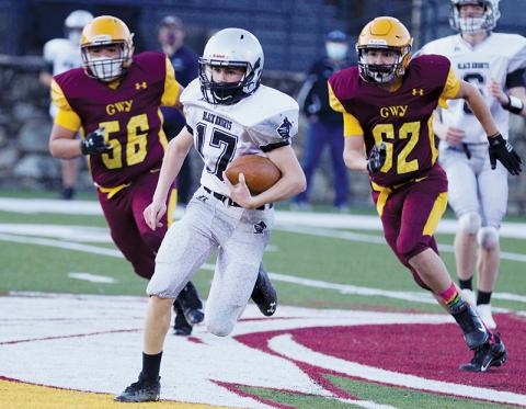 Cooper Adams creates some separation from a pair of Cherokee defenders during the junior varsity Black Knights’ 56-6, season-opening victory over the Braves. Photo by Scot McKie/Cherokee One Feather