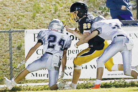 Junior varsity Black Knights Alexis Panama (24) and Christian Phillips (3) combine forces to take down Murphy’s Hunter Stalcup during March 4’s road game. Photo by Miranda Buchanan/Robbinsville High School Yearbook