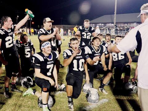 Black Knights head coach Dee Walsh (right) greets his team to celebrate clinching the Smoky Mountain Conference championship after defeating Murphy 17-7 on Friday. Photos by Miranda Buchanan/Robbinsville High School Yearbook