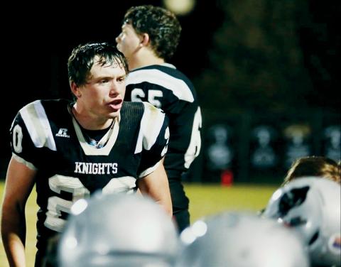 Senior running back Lex Hooper (20) pumps up his teammates during Friday’s first-round playoff matchup against Winston-Salem Preparatory Academy. Robbinsville would edge the Phoenix 42-40 for a wild double-overtime victory. Photos by Miranda Buchanan/Robbinsville High School Yearbook