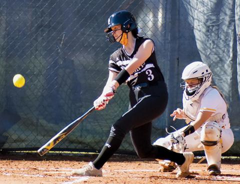 Lady Knights freshman Memory Frapp puts a charge into the ball during Monday’s road game at Murphy. The connection resulted in a double. Photo by Noah Shatzer/Cherokee Scout