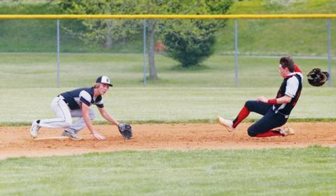 Robbinsville’s Cole Patterson crouches in preparation of thwarting Andrews’ A.J. Weaver on a stolen base attempt during May 11’s road game against the Wildcats. Photos by Miranda Buchanan/Robbinsville High School Yearbook