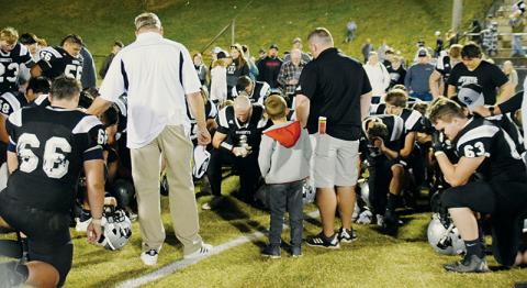 Members of the Robbinsville football program share the final post-game prayer of the 2020-21 season moments after falling 24-14 to Murphy in the Western Regional championship game. The loss ended the Black Knights’ defense of the state 1A championship. Photos by Art Miller/amiller@grahamstar.com