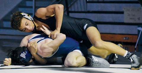 Robbinsville’s Jayden Nowell cinches in a hammerlock on Enka’s Damien Maxwell during a 132-pound bout May 15. The Knights will host the Smoky Mountain Conference tournament next week. Photo by Kevin Hensley/sports@grahamstar.com