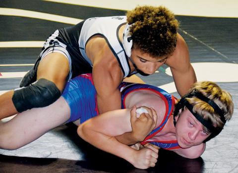 Jayden Nowell maintains top control over West Henderson’s Cody Eplee during Saturday’s home dual with the Falcons. Nowell would go on to cinch career win No. 101 in the bout. Photos by Art Miller/amiller@grahamstar.com