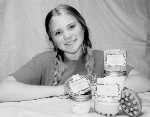 MyKala McGuire shows off a display of products from her goat farm. Photo by Angela McGuire/Contributing Photographer