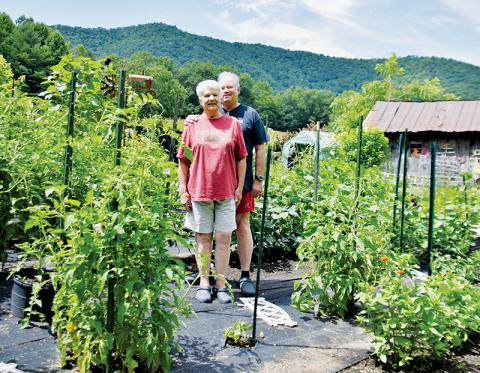 Kathie Hatton (front) and Len Sheffield have spent the last eight years focused on growing a plentiful garden on South Fork Road, following their respective retirements and full-time move to Graham County. Photos by Art Miller/amiller@grahamstar.com