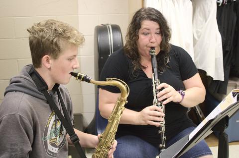 New Graham County Schools music educator Amber Watkins (right) works one-on-one with freshman tenor saxophonist Ryan Lynn Monday. The band is currently preparing its marching show for the upcoming season. Photo by Charlie Benton/news@grahamstar.com