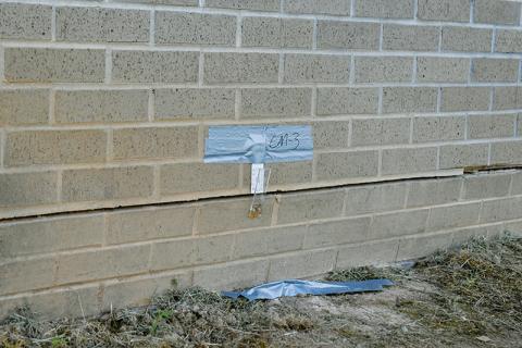 In this May 21 photo, a crack monitor measures the expansion around the foundation of Robbinsville Elementary School’s gymnasium. Photo by Kevin Hensley/sports@grahamstar.com