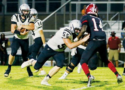 Sophomore tackle Koleson Dooley (55) runs interference for classmate Cuttler Adams (4) during Friday’s season opener against the Asheville Cougars. Along with another sophomore – Kage Williams – Adams had three touchdowns in Robbinsvile’s 45-23 victory. Photo by Miranda Buchanan/Robbinsville High School Yearbook