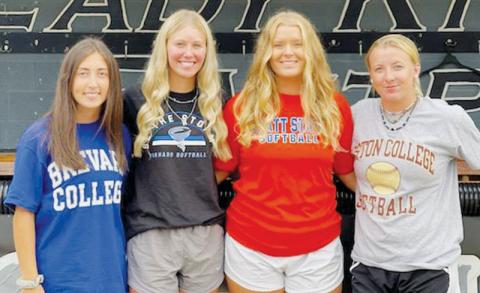 Lady Knights softball alumni Gabby Hooper, Mikayla Morgan, Maggie Knight and Abigail Knight (from left) have each continued their careers at the collegiate level.