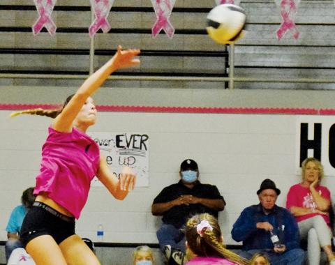 With senior Kelsey Waldroup (2) looking on, Robbinsville sophomore Delaney Brooms fires a shot back to Cherokee during Tuesday’s Pink Game against the Lady Braves. Photo by Art Miller/amiller@grahamstar.com