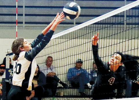 Lady Knights senior Yeika Jimenez (20) gets a fingertip on Addy Shaver’s return during Saturday’s first-round playoff match against South Stokes. Photo by Montana Buchanan/Robbinsville High School Yearbook