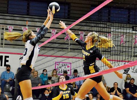 Yeika Jimenez (left) stretches to block a tip by Murphy’s Torin Rogers during Oct. 7’s conference match. Photos by Art Miller/amiller@grahamstar.com