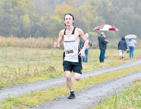 Robbinsville senior Hayden Stewart gutted out the rainy conditions at Saturday’s 1A Western Regional Meet in Bryson City to finish 11th, punching his ticket to the state race. Photo by Kevin Hensley/sports@grahamstar.com