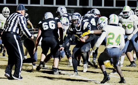 Sophomore fullback Kage Williams pushes across the goal line Friday night against North Rowan. Williams had two rushing touchdowns in Robbinsville’s 50-47 third-round playoff win over the Cavaliers. Photo by Art Miller/amiller@grahamstar.com