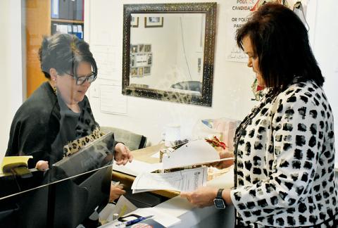 Graham County Board of Elections Deputy Director Tasha Holder (left) helps incumbent Graham County Clerk of Court Tammy Holloway with the filing process Monday. Holloway was the first candidate to file for any 2022 local election. Photo by Kevin Hensley/editor@grahamstar.com