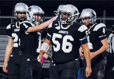 Carlos Wesley (56) receives some recognition from Zeke Silvers (1) during Robbinsville’s first-round playoff game against Winston-Salem Preparatory Academy on Nov. 5. Wesley was named the Smoky Mountain Conference Player of the Year. Photo by Art Miller/amiller@grahamstar.com
