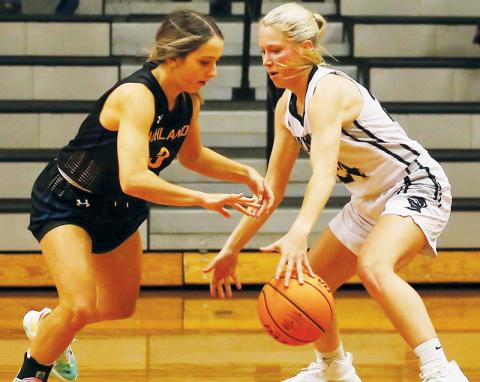 Robbinsville junior Kensley Phillips swats the ball away from Highlands’ Beatrice Bryson during Tuesday’s season opener. Phillips’ defense played a key role in the Lady Knights’ 59-39 win over the Lady Highlanders. Photo by Miranda Buchanan/Robbinsville High School Yearbook
