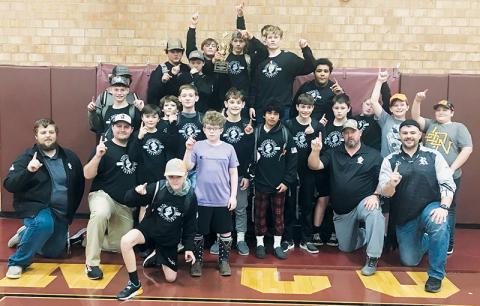 Members of the Robbinsville Middle School wrestling program celebrate the Knights’ 2021-22 Smoky Mountain Conference tournament championship, after the team clinched the crown Dec. 15 at Swain County. Photo courtesy of Crystal Hooper/Contributing Photographer