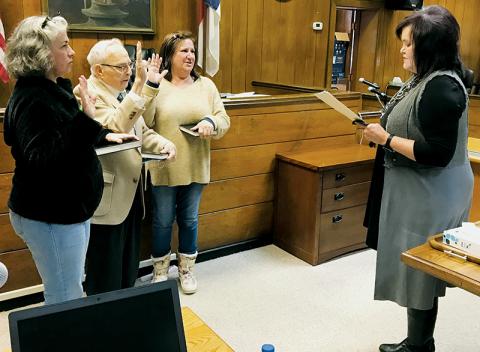 Graham County Clerk of Court Tammy Holloway (right) swears in the new Town of Lake Santeetlah councilmembers Tuesday afternoon (from left): Tina Emerson, Ralph Mitchell and Connie Gross. Recent appeals at both the local and state level have  attempted to dispute the legitimacy of Emerson and Gross’ residency, but both challenges have been dismissed. Photo by Kevin Hensley/editor@grahamstar.com