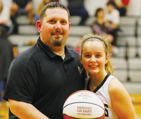 Junior point guard Desta Trammell scored her 1,000th career point Tuesday night against Swain County. Robbinsville head coach Lucas Ford presented Trammell with a commemorative ball after the game. Photo by Miranda Buchanan/Robbinsville High School Yearbook