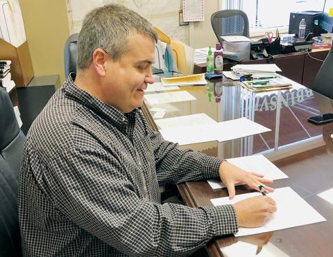 Robbinsville Mayor Shaun Adams signs the first alcholic beverage permit – issued to Ingles – on Jan. 20.