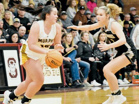 Delaney Brooms (right) keeps pace with Murphy’s Amber Martin during Robbinsville’s Smoky Mountain Conference Tournament finals showdown with the Lady Bulldogs on Friday. Photo by Kevin Hensley/sports@grahamstar.com