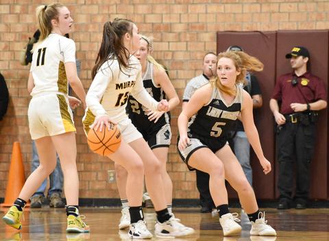 Robbinsville senior Halee Anderson (5) keeps tabs on Murphy's Addie Johnson during tonight's Smoky Mountain Conference Tournament finale at Swain County High School. Photo by Kevin Hensley/sports@grahamstar.com