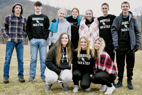 Robbinsville’s indoor track team bundled up and showed off at the Feb. 2 Smoky Mountain Conference championship meet in Cherokee. Kneeling in front (from left): Montana Buchanan, Haize Moore and Caylin Lunsford. Standing (from left): Caden Lail, Roman Jones, Kensley Phillips, Zoie Shuler, Delaney Brooms, William Cable and Zeb Stewart. Photo by Kevin Hensley/sports@grahamstar.com