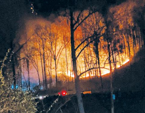 Dry, windy conditions over the weekend sparked wildfires all over the region. Here, a tree limb severed an electrical line at Fontana Dam on Saturday afternoon, leading to a blaze that lasted late into the night. Photo courtesy of Zelerie Rogers