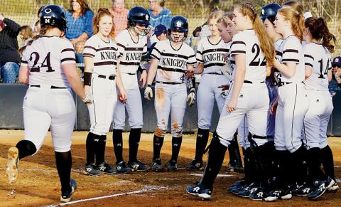 The Robbinsville Lady Knights wait to greet Ivy Odom at home plate, after the senior first baseman slugged one of her two home runs over the fence in Friday’s victory against T.C. Roberson. Photo by Miranda Buchanan/Robbinsville High School Yearbook