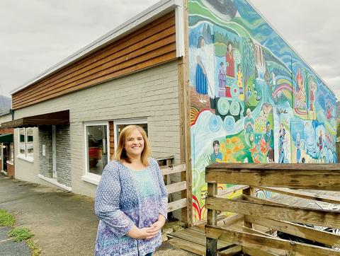 Angie Knight, superintendent of Graham County Schools, in front of the old VFW building on Main Street in Robbinsville. The school district received a $511,500 grant to restore and convert the building into a sandwich and coffee shop – as well as imprinting shop – to teach high school students real-world skills. Photo by Randy Foster/news@grahamstar.com