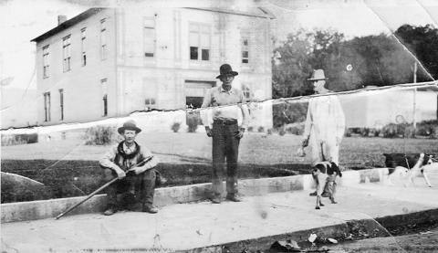 Charles Zachery Denton, Lloyd Jackson and Arthur Rogers (left) pause in front of the old wood courthouse in Robbinsville.