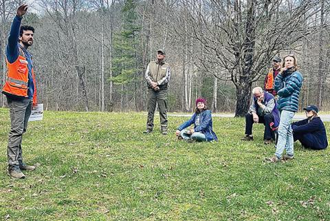 Aaron Whittemore (left) with the Hemlock Restoration Initiative describes the difference between healthy and unhealthy hemlock trees near Robbinsville on March 29. Photos by Randy Foster/news@grahamstar.com