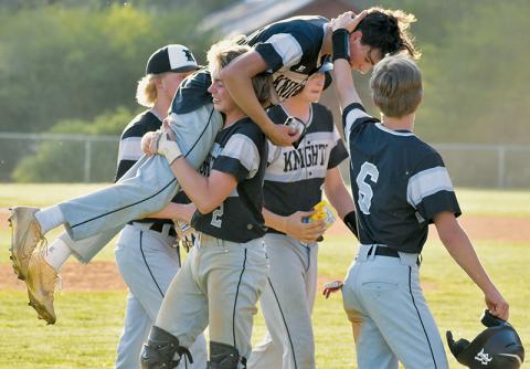As Cole Patterson hoists Christian Phillips in the air Monday, Graylen Orr (right) walks by to congratulate Phillips on his extra-inning, walk-off single against Andrews on Monday. Photo by Kevin Hensley/sports@grahamstar.com
