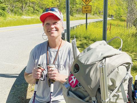 Kelly Karr poses at Stecoah Gap in Graham County on May 5 during a break in her 2,190-mile hike on the Appalachian Trail. Photo by Randy Foster/news@grahamstar.com