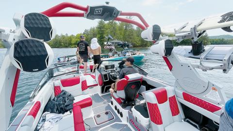 Malibu Boats company officials and professional athletes and models rendezvous in Lake Santeetlah on May 18, to compare notes during a lake cleanup. The group is at the lake for two weeks to shoot promotional videos for the premium ski boats. Photos by Randy Foster/news@grahamstar.com