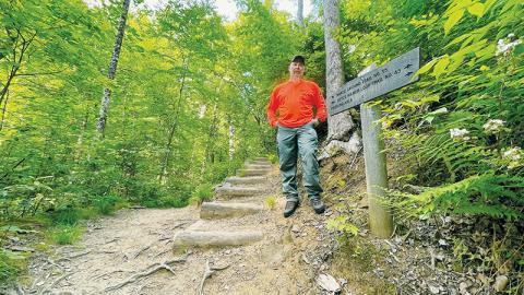 Graham County Search and Rescue Coordinator Tory Lynnes stands at the fork between Joyce Kilmer Loop Trail (left) and Naked Ground Trail (right). Naked Ground Trail is a difficult trail that does not loop. Joyce Kilmer Memorial Forest day hikers sometimes get confused, take the right fork and sometimes have to be rescued. Photos by Randy Foster/news@grahamstar.com