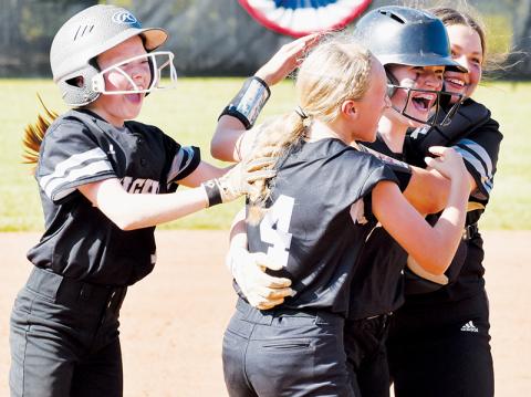 Robbinsville Middle School’s Daphne Barlow (second from right) is mobbed by teammates Kynadee Spencer, Khaygen Buchanan and Dreylee Webster (from left) after her walk-off hit May 11 against Cherokee, which lifted Robbinsville to a 2-1 victory in the season finale. Photos by Kevin Hensley/sports@grahamstar.com