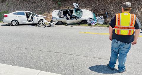 A firefighter from Valleytown Fire Department in Andrews helps direct traffic at a collision in Topton on April 28. Photo by Randy Foster/news@grahamstar.com