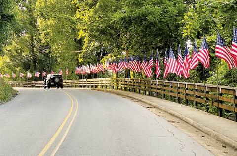 Work is in progress to rename East Main Street in Robbinsville “Veteran Hill.” Here, the street is decked out with U.S. flags and memorials for Memorial Day Weekend. Photo by Randy Foster/news@grahamstar.com