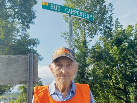Town of Robbinsville employee Bud Carpenter stands at the intersection of Rodney Orr Bypass and Bud Carpenter Drive. The previously-unnamed private street, which leads to the town’s maintenance yard, was named in his honor about four years ago. At age 95, Carpenter is one of the oldest municipal employees anywhere. Photos by Randy Foster/news@grahamstar.com